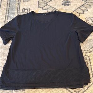 Lululemon size 6 short sleeve black tee with double layer ruffle trim on bottom